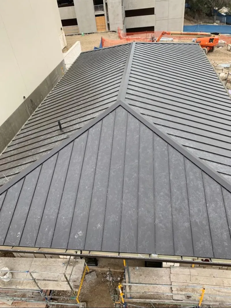 Commercial metal roof construction with crane equipment in Cimarron Hills