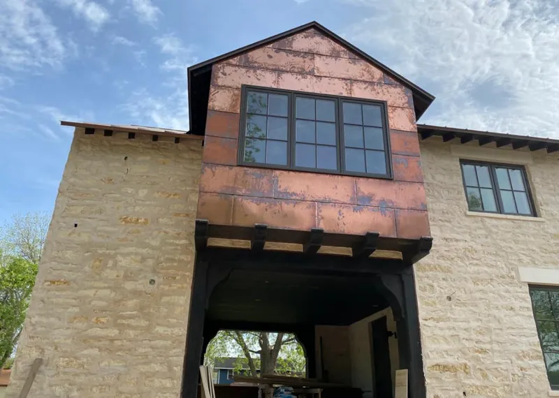 Copper metal panel facade on a stone building for Skylight Installation in Cimarron Hills